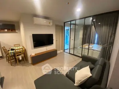 Modern living room with glass partition and dining area in stylish apartment