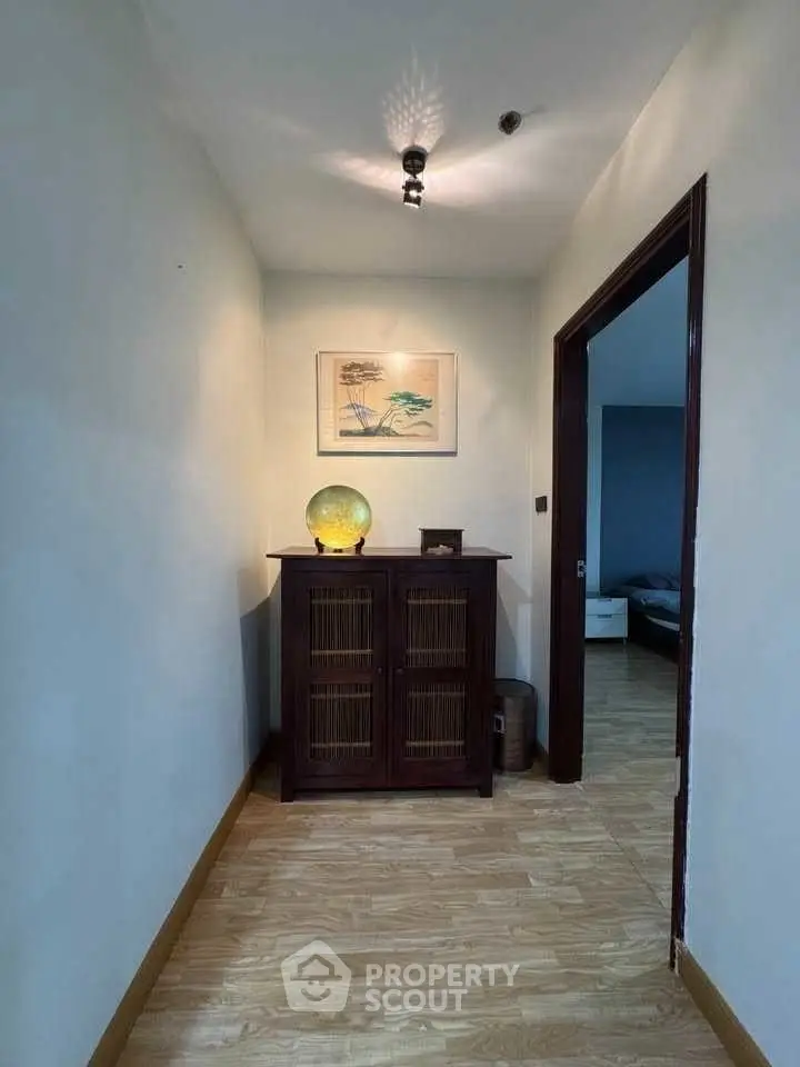 Charming hallway with wooden cabinet and ambient lighting in modern home