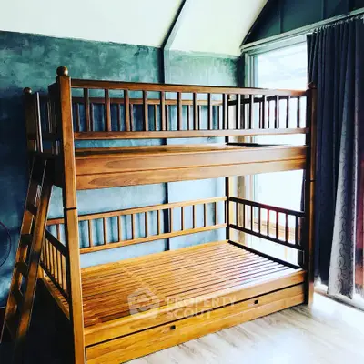 Spacious bedroom with wooden bunk bed and natural light