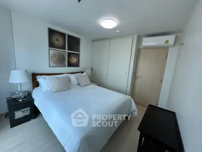 Modern bedroom with stylish decor and ample natural light