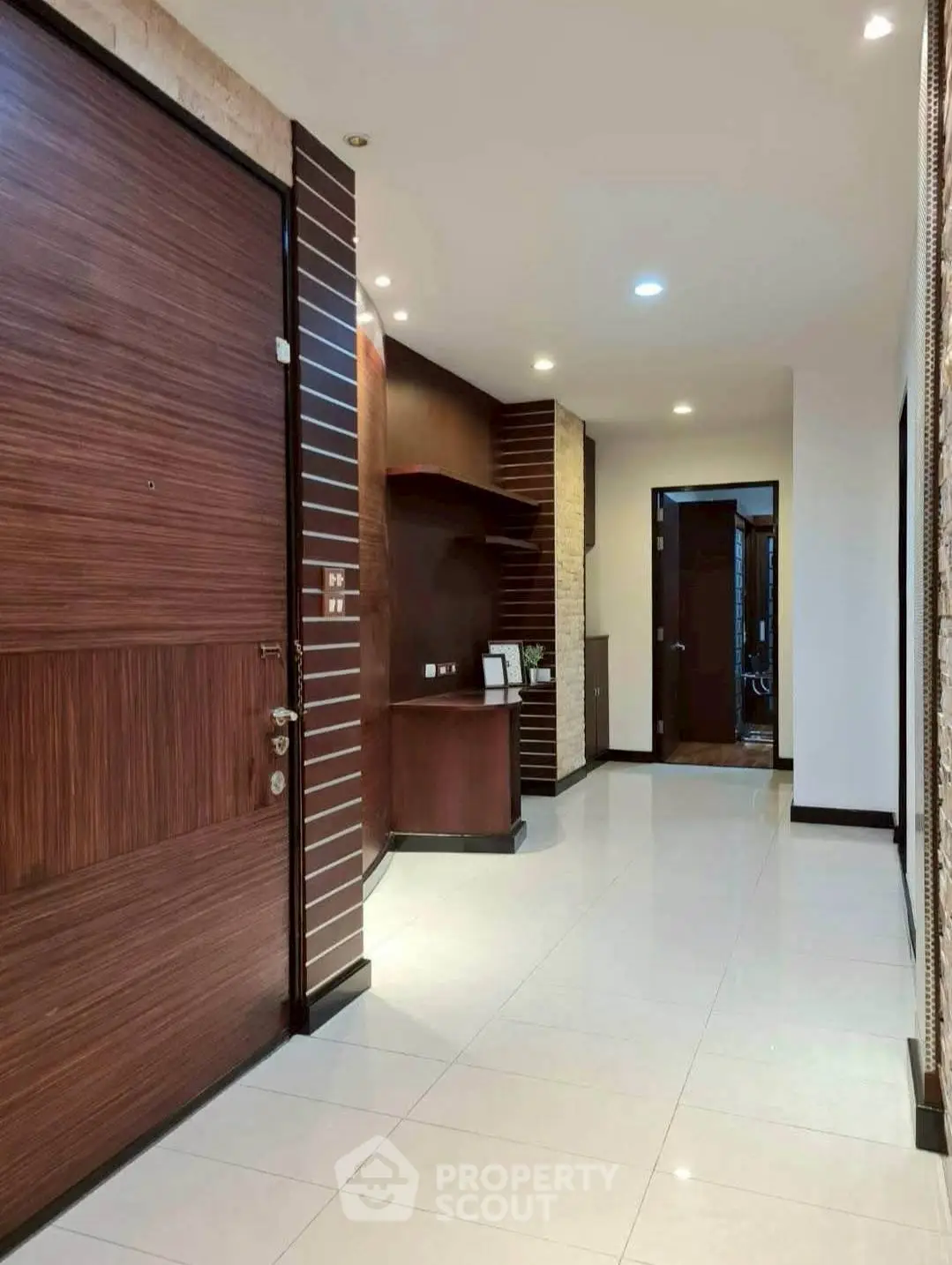 Modern apartment entrance with sleek wooden door and stylish interior design