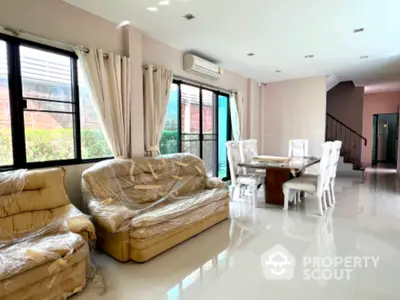 Spacious living room with elegant dining area and natural light