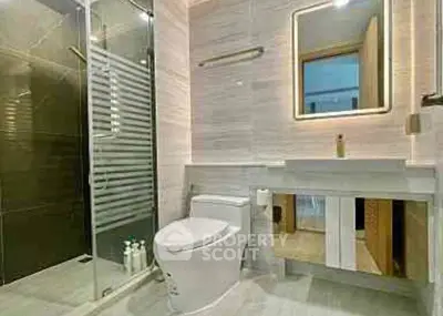 Modern bathroom with glass shower and illuminated mirror