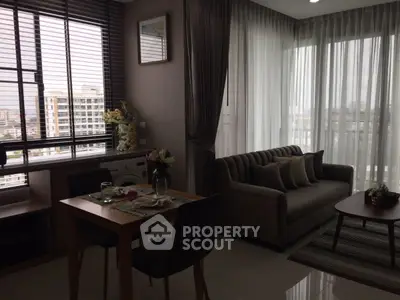 Modern living room with dining area and city view, featuring elegant decor and natural light.