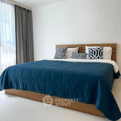 Spacious bedroom with modern decor and large bed, perfect for relaxation.