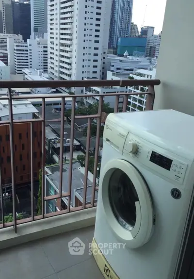Urban balcony with washing machine and city skyline view