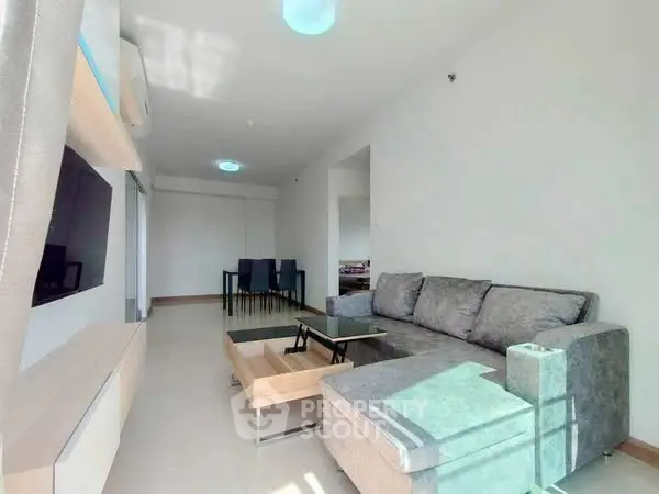 Spacious modern living room with sleek furniture and ample natural light