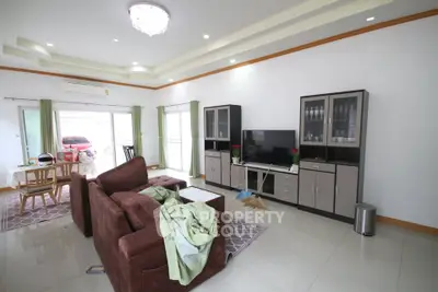 Spacious living room with modern furniture and large windows for natural light.
