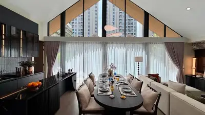 Luxurious modern living room with high ceilings and elegant dining area, featuring large windows with city view.