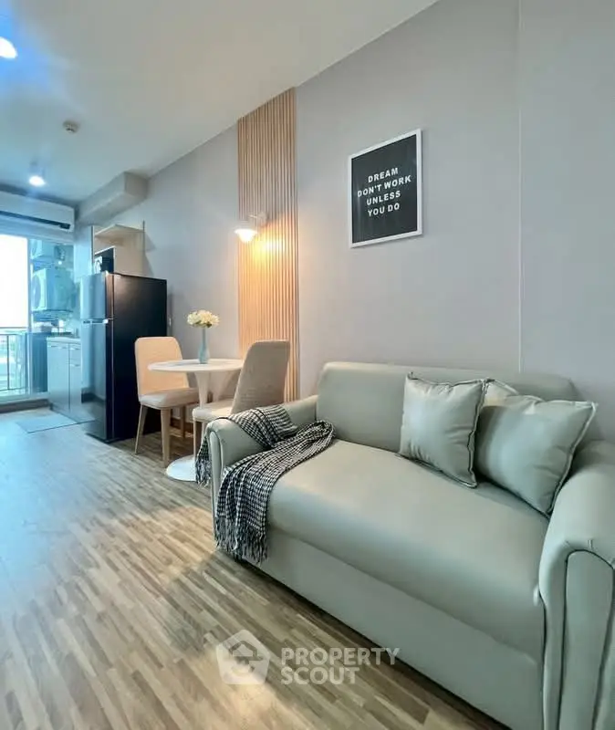 Modern living room with cozy sofa, dining area, and open kitchen in stylish apartment.