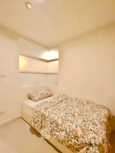 Cozy bedroom with floral bedding in modern apartment