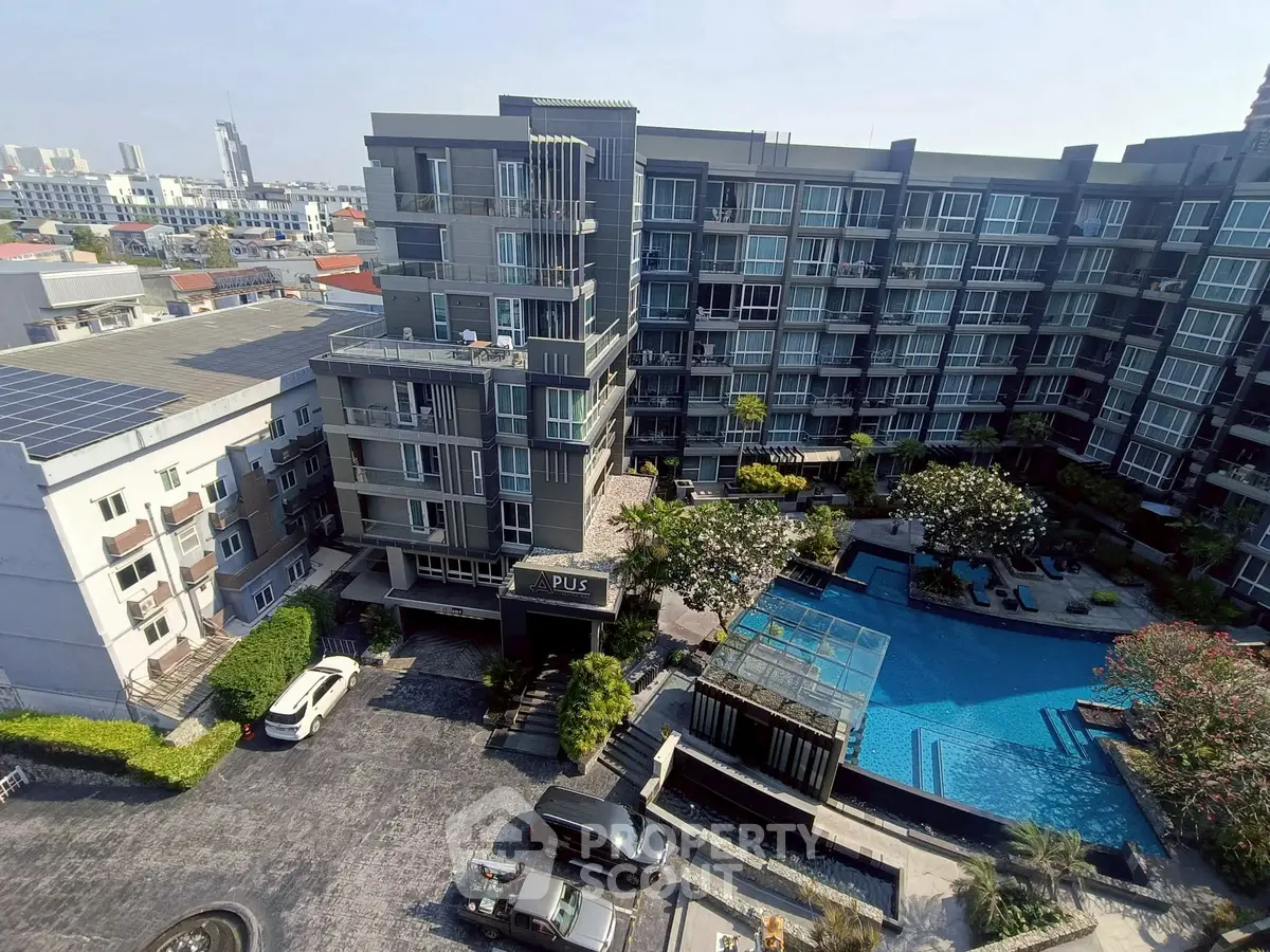 Modern apartment complex with pool and city view, ideal for urban living.