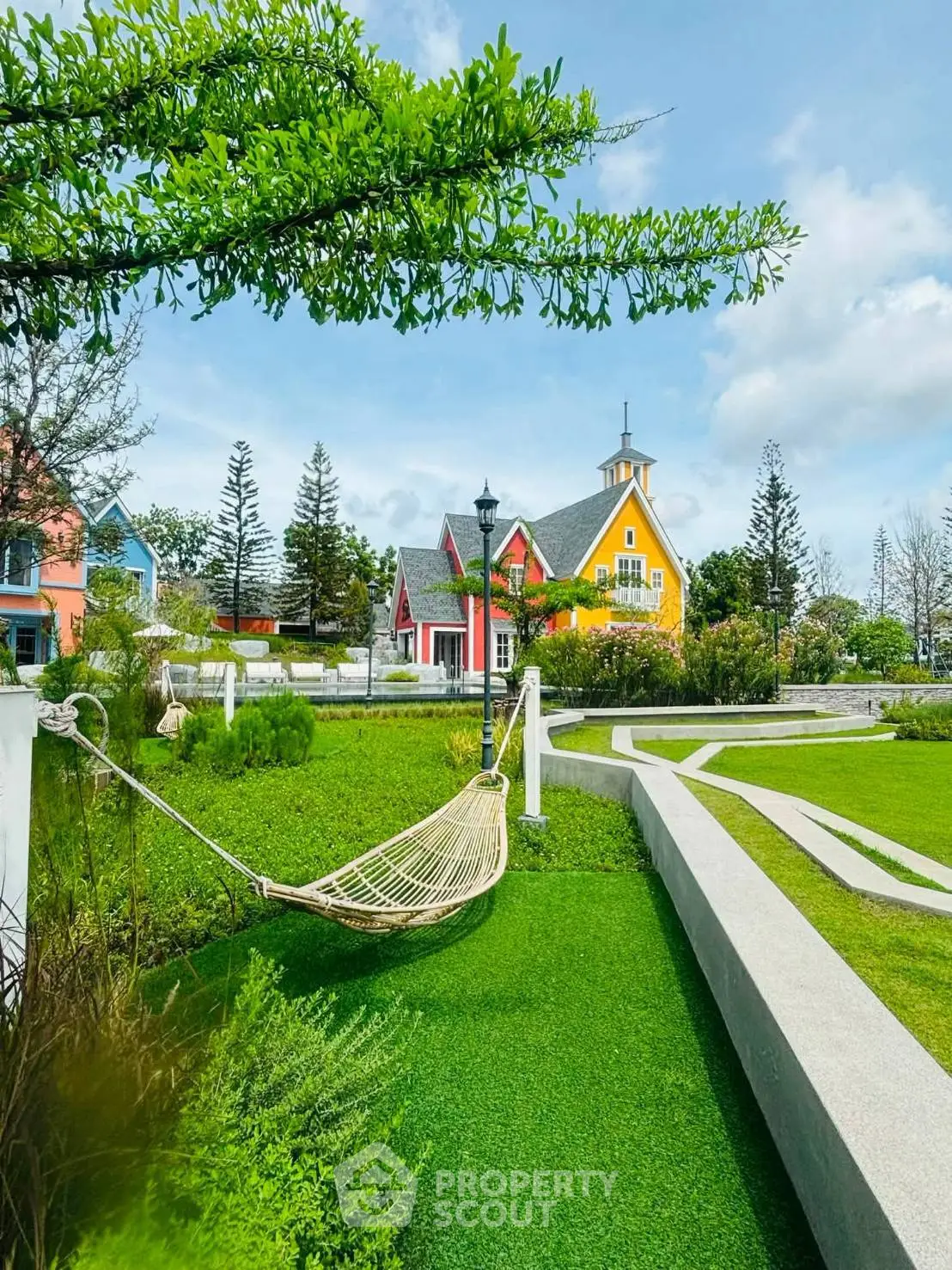 Charming colorful house with lush garden and hammock, perfect for relaxation and outdoor enjoyment.