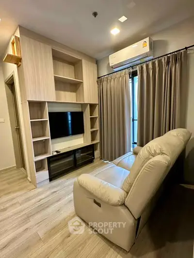 Modern living room with sleek wooden shelving, cozy beige sofa, and wall-mounted air conditioner.
