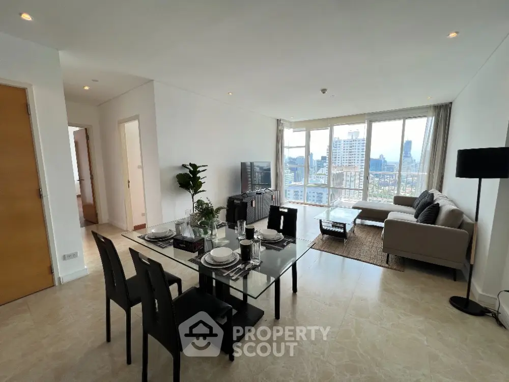 Spacious modern living room with city view, elegant dining area, and stylish decor.