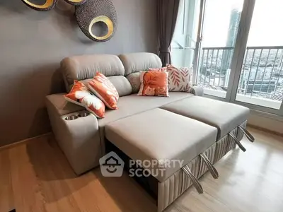 Modern living room with stylish sofa bed and city view balcony.