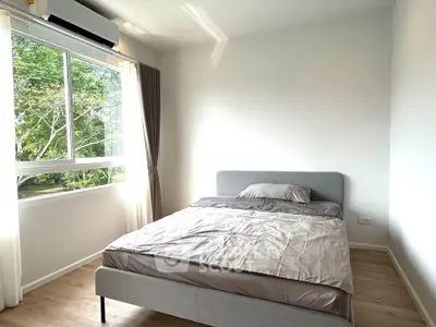 Bright and cozy bedroom with large window and modern decor