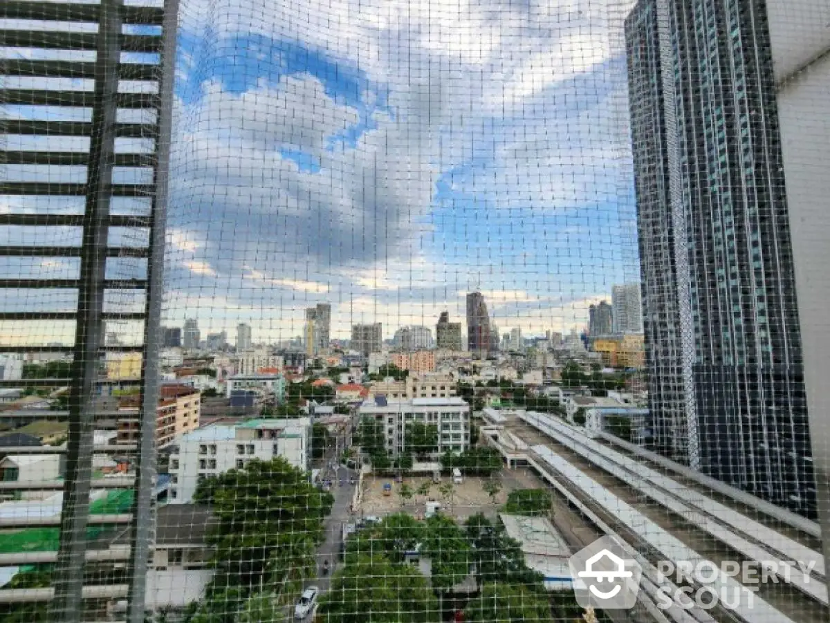 Stunning cityscape view from high-rise balcony in urban residential area.