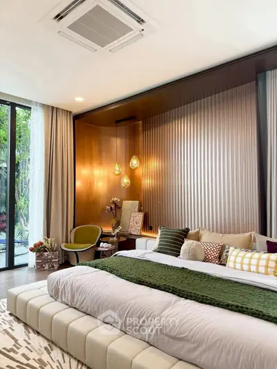 Luxurious bedroom with elegant decor and large windows offering garden view.