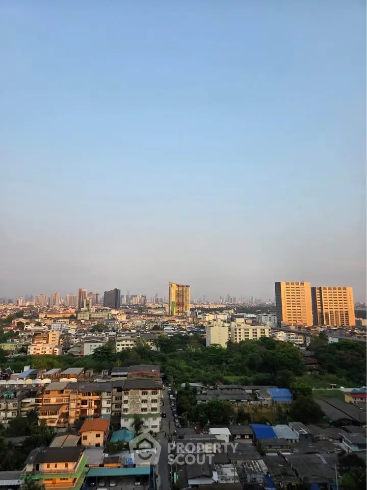 Stunning cityscape view from high-rise building showcasing urban skyline at sunset.
