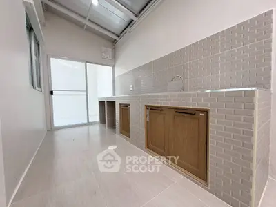 Modern kitchen with sleek cabinetry and tiled backsplash in bright, airy space.
