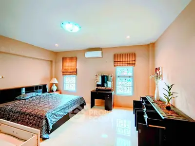 Spacious bedroom with modern decor and ample natural light