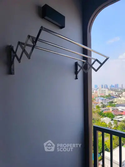 Modern balcony with city view and retractable clothes drying rack