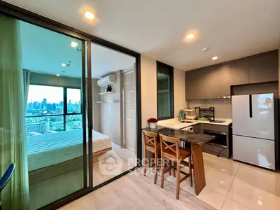 Modern open-plan kitchen with dining area and city view bedroom