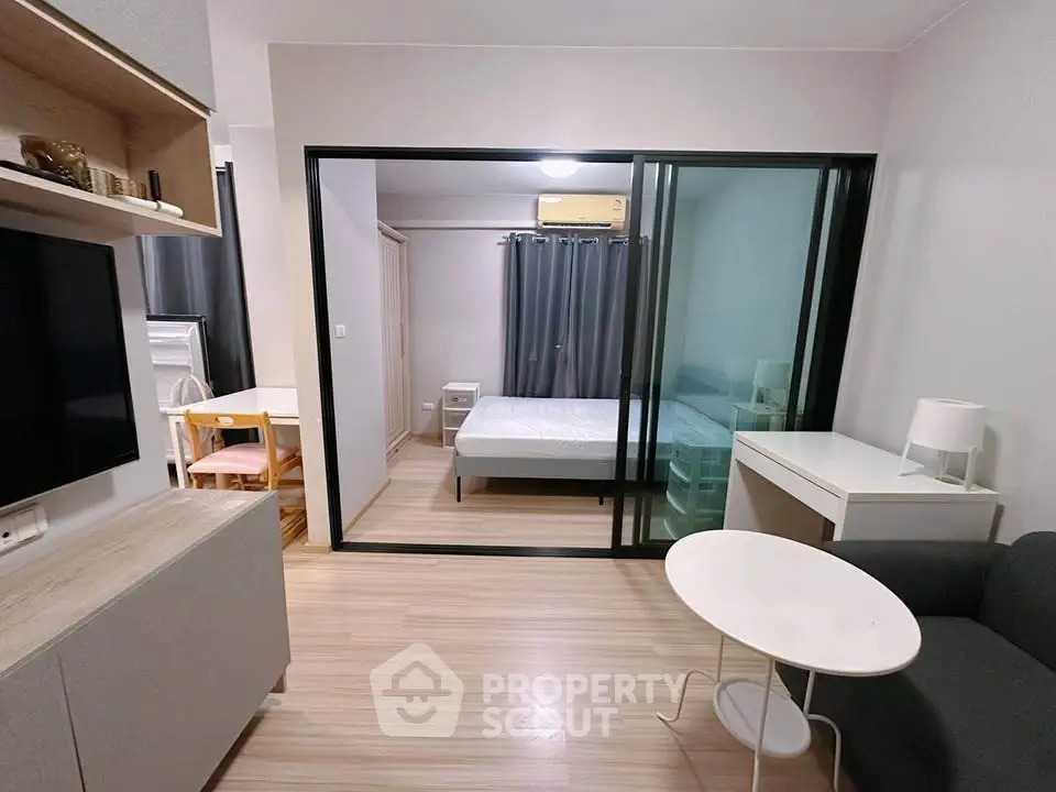 Modern studio apartment with sliding glass doors and minimalist decor