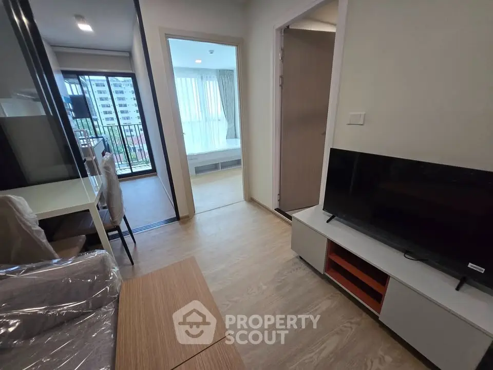 Modern apartment interior with open living area and balcony view