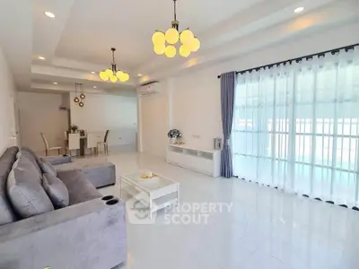 Spacious modern living room with elegant lighting and large windows