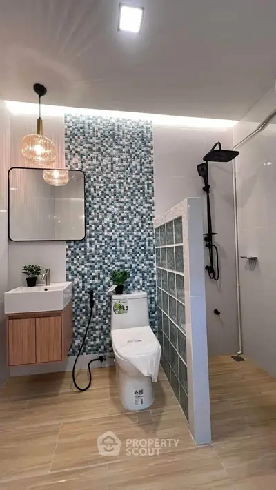 Modern bathroom with stylish mosaic tiles and elegant lighting