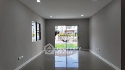 Spacious modern living room with large windows and glossy tiled floor