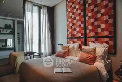 Luxurious bedroom with modern decor and large window offering natural light.