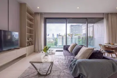 Modern living room with large windows and city view, featuring stylish furniture and decor.