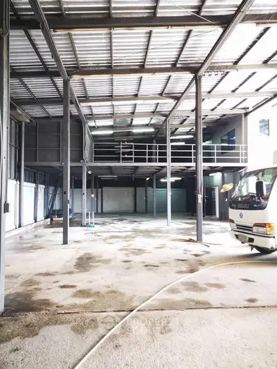 Spacious industrial warehouse with high ceilings and mezzanine level for versatile use.