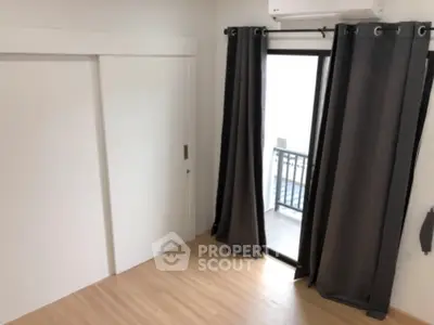 Modern bedroom with sliding closet doors and balcony access.