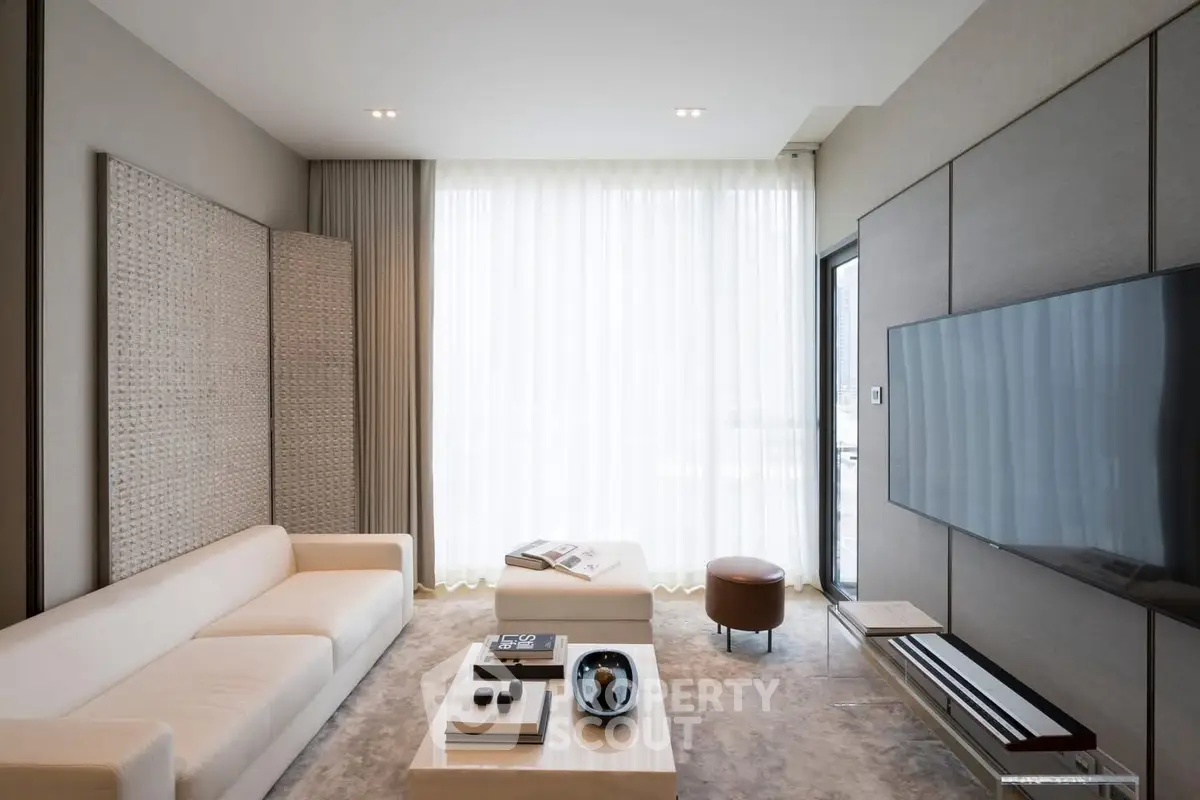 Luxurious modern living room with sleek design and large TV, perfect for relaxation and entertainment.