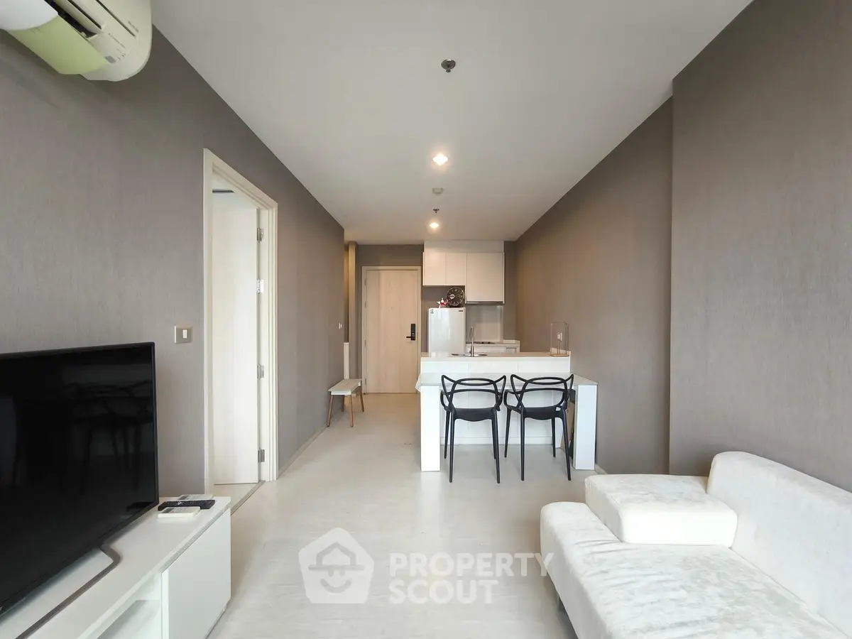 Modern living room with open kitchen and stylish furniture