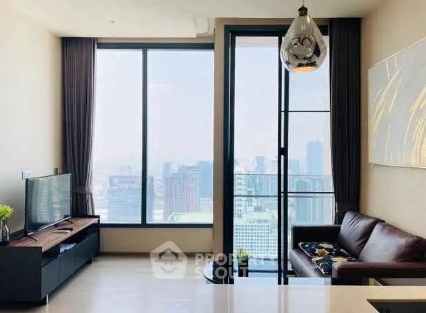 Modern living room with large windows offering stunning city views and stylish decor.