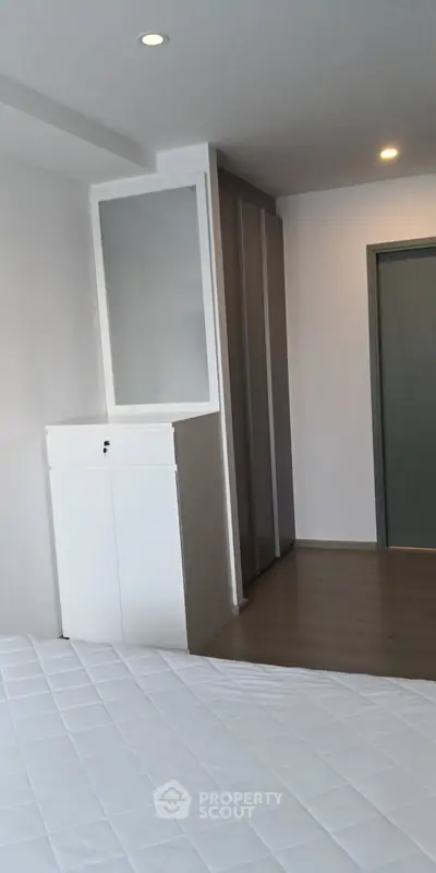 Modern bedroom with sleek wardrobe and minimalist decor