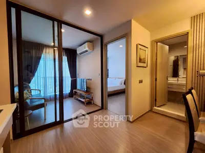 Modern apartment interior with glass partition, cozy living area, and elegant bedroom.