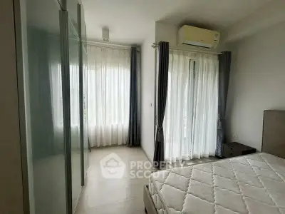 Bright bedroom with large windows and air conditioning in modern apartment