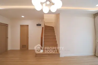 Spacious modern interior with wooden staircase and elegant lighting