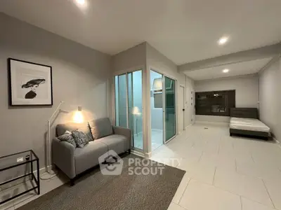 Modern living room with sleek design, cozy sofa, and stylish decor in a spacious apartment.
