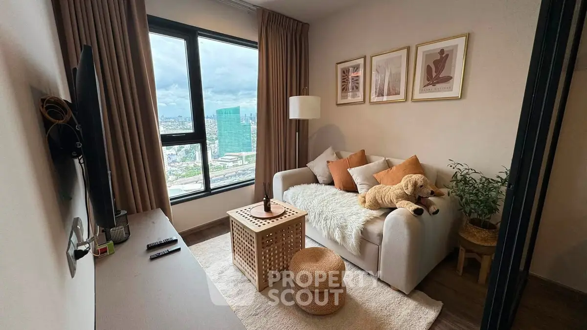 Cozy living room with city view, featuring a plush sofa, stylish decor, and large window for natural light.