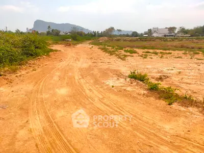 Expansive plot of land with scenic mountain backdrop, ideal for development opportunities.