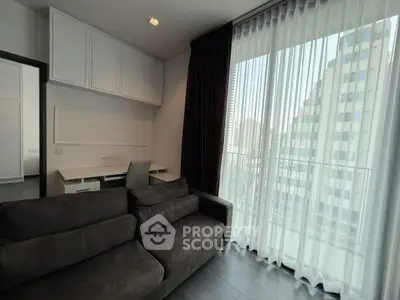 Modern living room with sleek sofa and large window offering city view