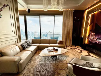 Luxurious living room with panoramic city view, elegant decor, and plush seating in a high-rise apartment.