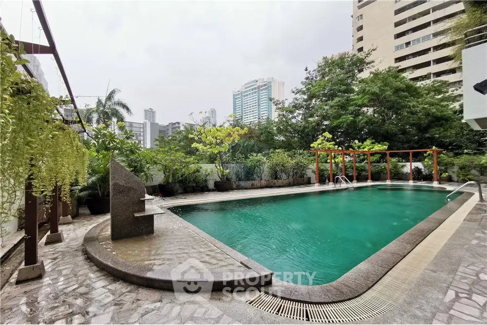 Luxurious urban pool with lush greenery and cityscape views, perfect for relaxation and leisure.
